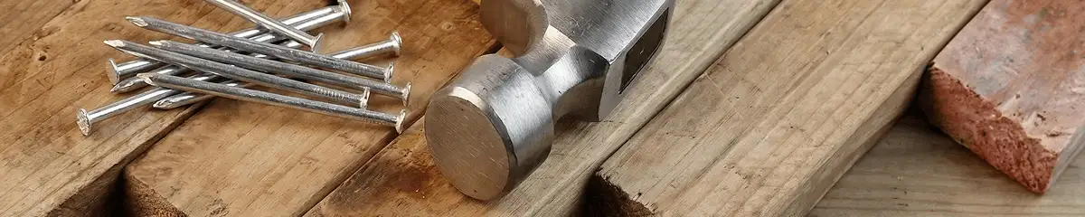 Hammer and nails on hardwood flooring boards in Columbus, GA
