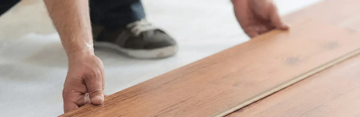 A professional installing laminate flooring in Columbus, GA